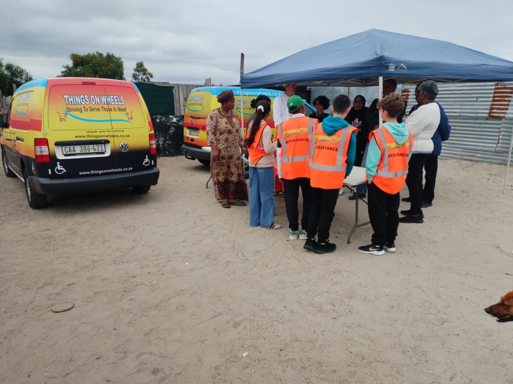 Things On Wheels vehicles and volunteers assisting a community