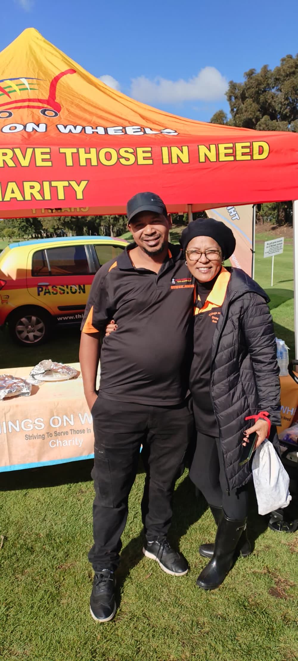 Things On Wheels team members smiling together at an event